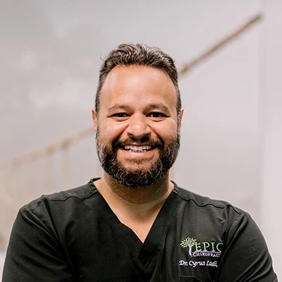 Chiropractor Cyrus Laali Smiling In Black Polo
